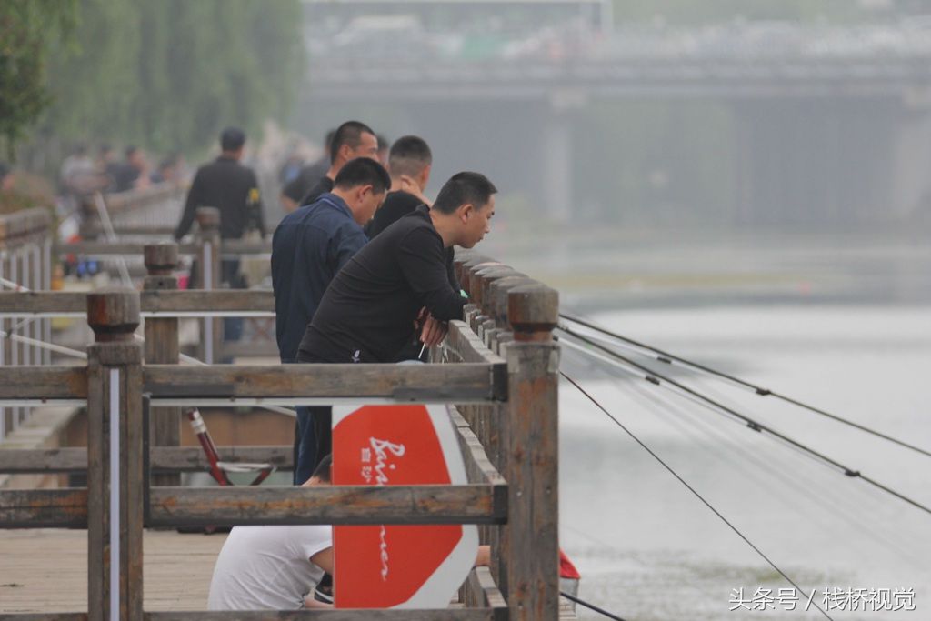 大雨过后河中鱼儿真多，青岛市民扎堆钓鱼乐真是舒坦